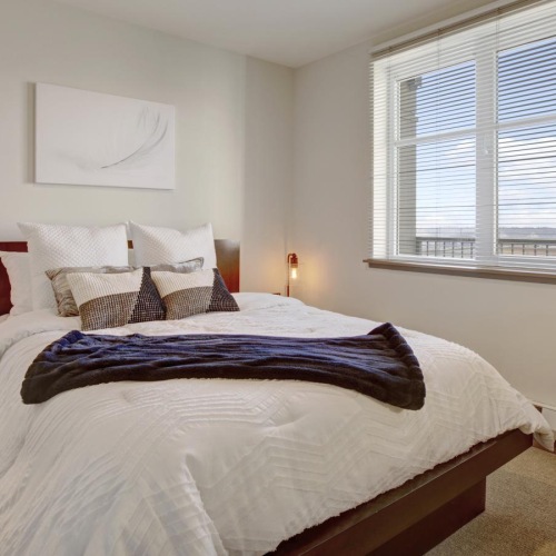 Generous bedroom offerings to fit every family a bedroom with a bed and a window