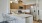 a kitchen with a white table and chairs