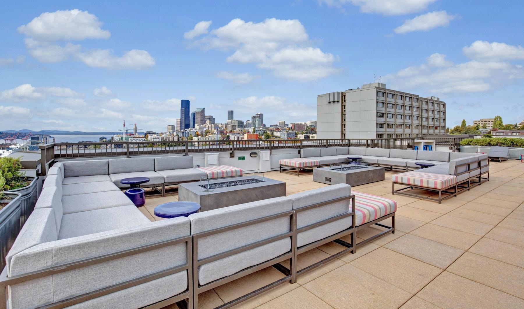a deck with benches and a body of water in the background